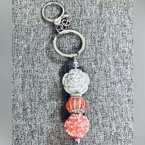 Silver and coral/orange keychain